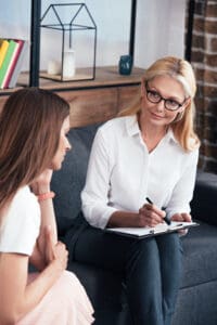 a women learning about What Daily Life Looks Like in a PHP Program in Massachusetts from a female therapist