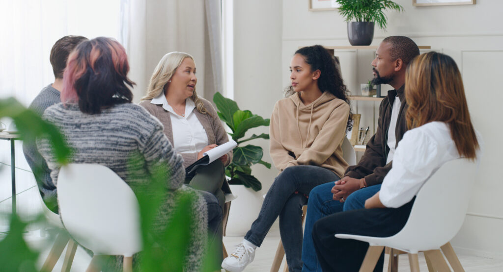 individuals in group therapy which is a part of daily life in a PHP program in Massachusetts