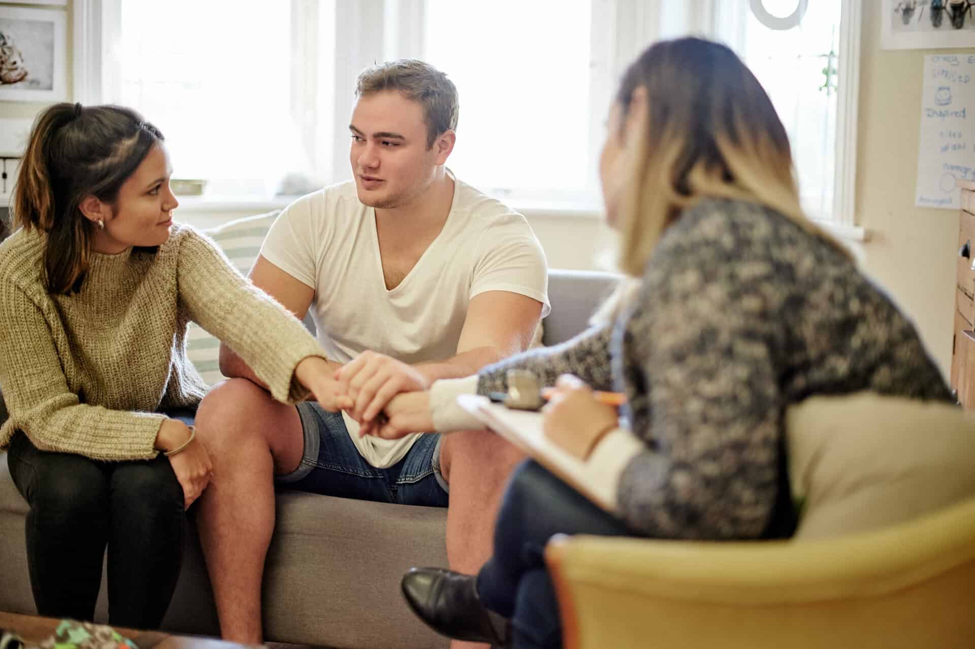 couple speaking with admissions as males is questioning do i need rehab