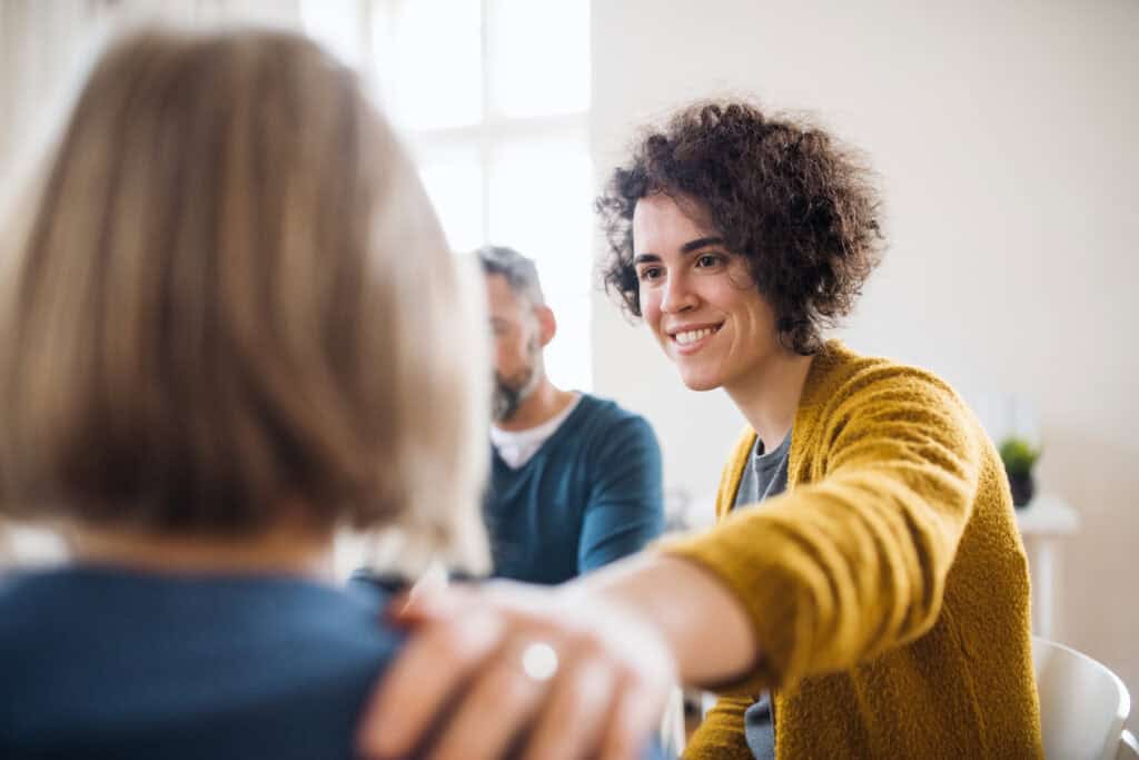 group of people supporting each other at treatment center